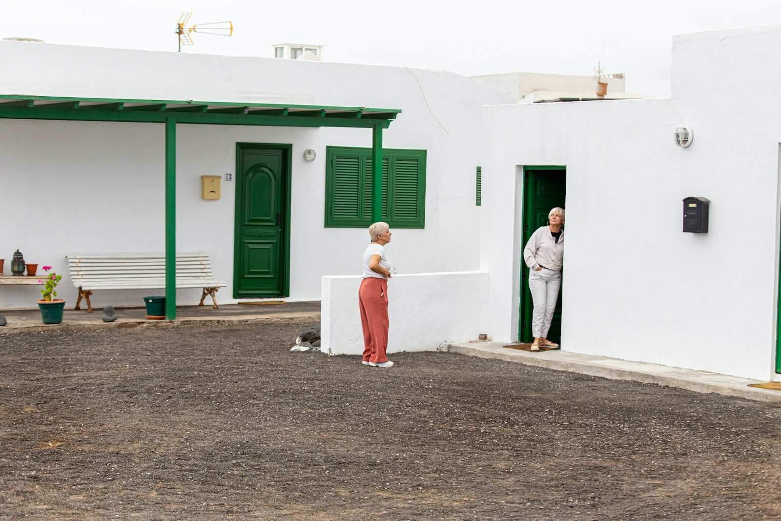 a couple of people standing outside of a building